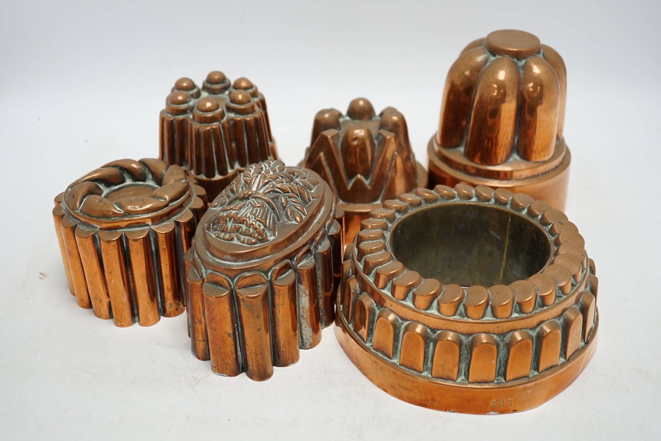 Six Victorian copper jelly moulds, tallest 14.5cm high. Condition - good